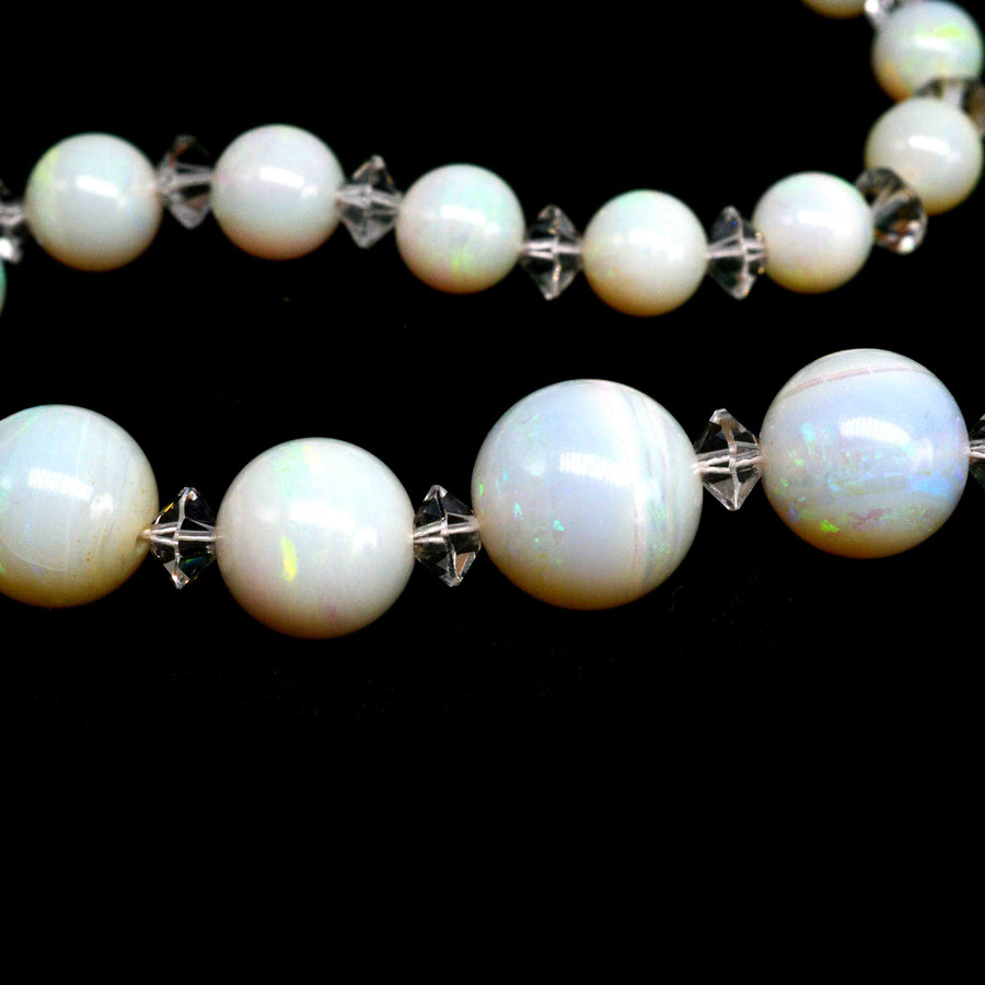 Early 20th century graduated opal bead necklace with rock crystal beads, showcasing luminous hues and enchanting highlights.