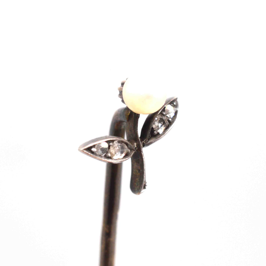 Austro-Hungarian 14ct gold tie pin featuring a pearl flower and rose cut diamond leaves, showcasing exquisite craftsmanship.