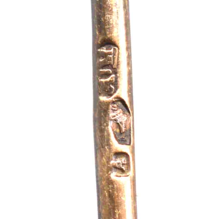 Close-up of hallmark on an Austro-Hungarian 14ct gold tie pin, showcasing intricate craftsmanship.