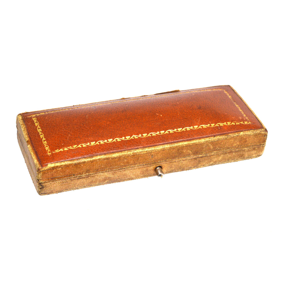 Antique brown leather box with gold trim, ideal for storing jewelry or keepsakes.