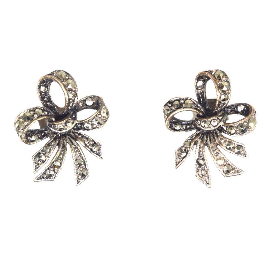 Edwardian silver marcasite bow earrings, showcasing elegant design and vintage charm, perfect for any special occasion.
