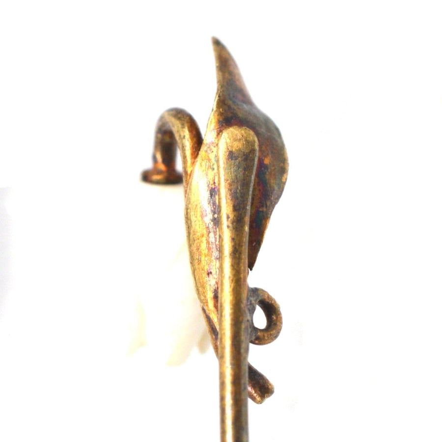 Close-up of rare Regency 9ct gold carved white coral Lily of the Valley tie pin, highlighting intricate details.