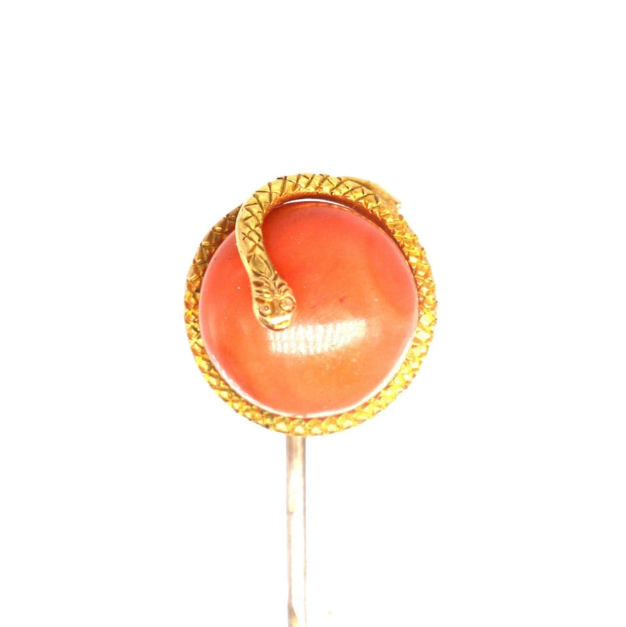 Victorian 15ct gold snake tie pin with coral bead, symbolizing everlasting love and protection.