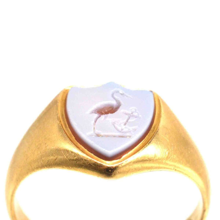 Victorian 18ct gold signet ring featuring carnelian intaglio of stork and anchor, symbolizing elegance and history.
