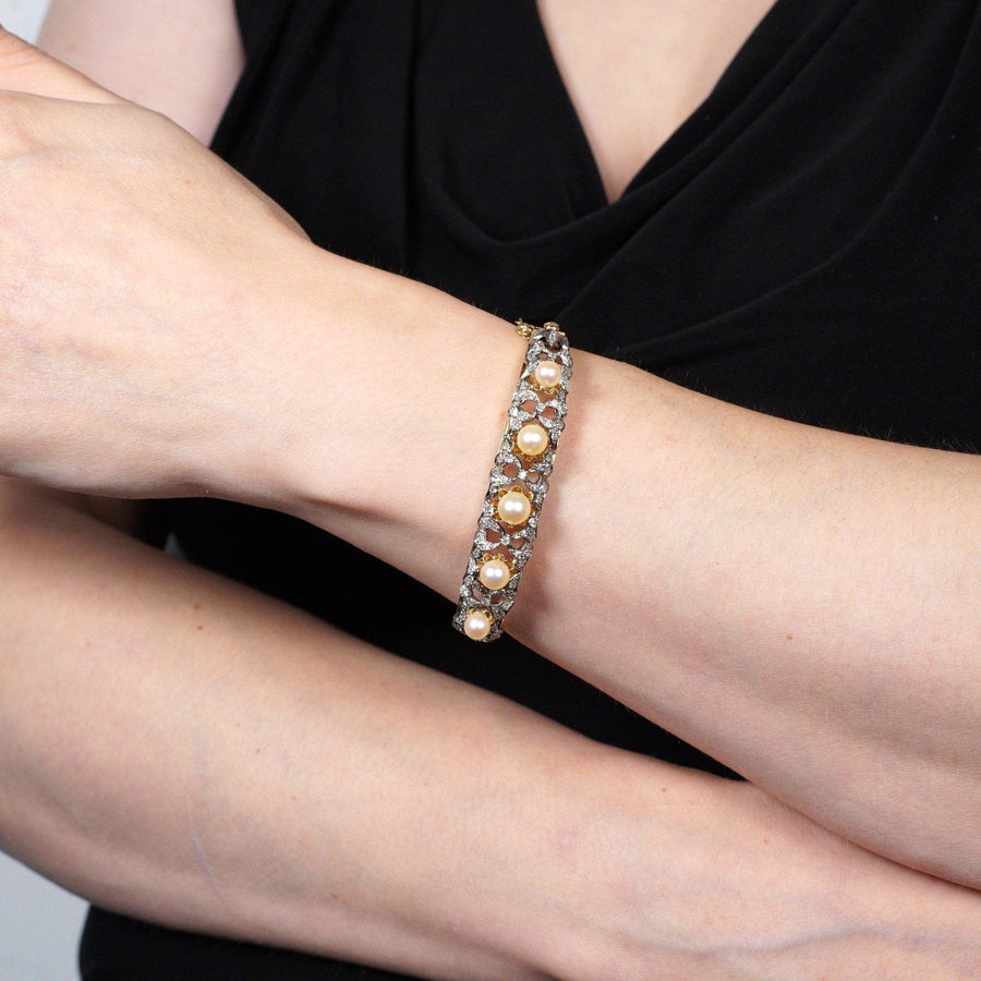 1940s 18ct gold bangle with cultured pearls and diamonds, showcasing elegance and luxury on a wrist.