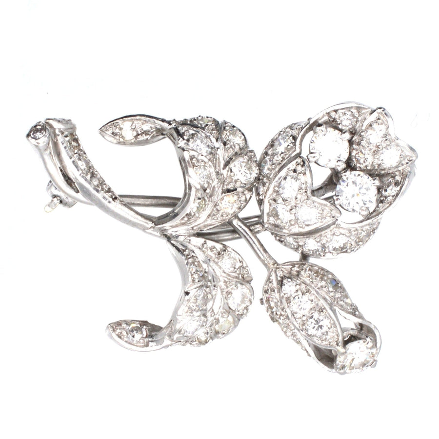 1950s white gold diamond flower spray brooch, featuring two flowers, dazzling diamonds, and intricate craftsmanship.