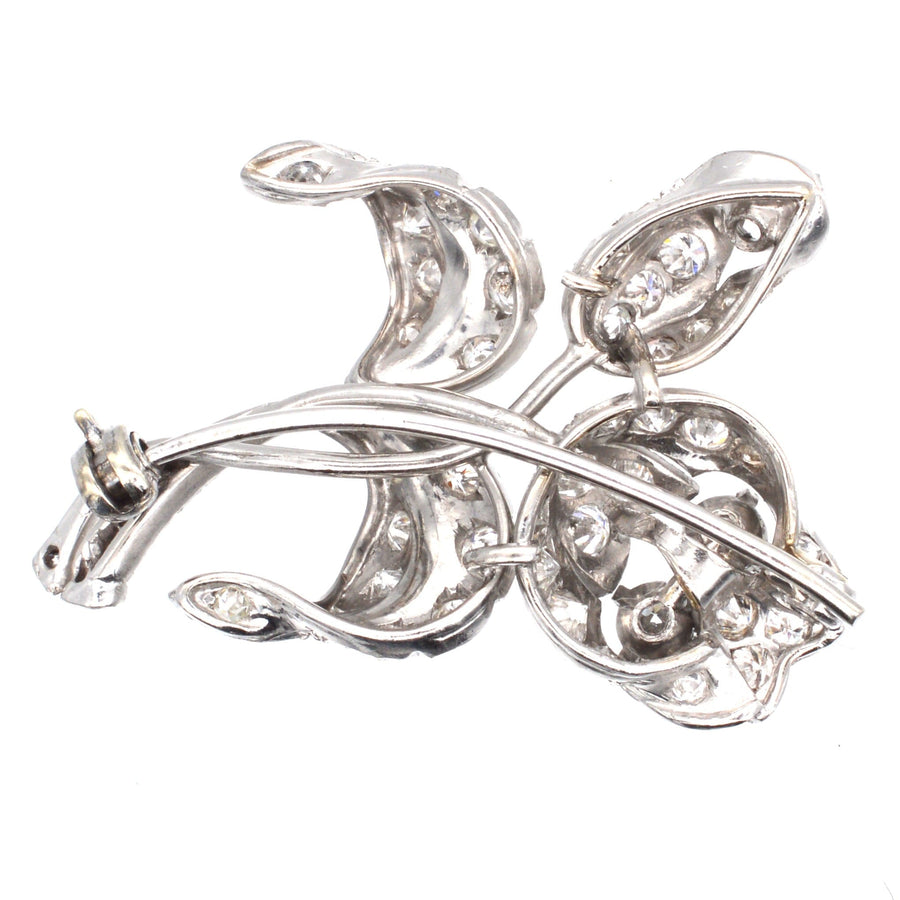 1950s 18ct white gold diamond flower spray brooch featuring exquisite craftsmanship and a sculptural design.