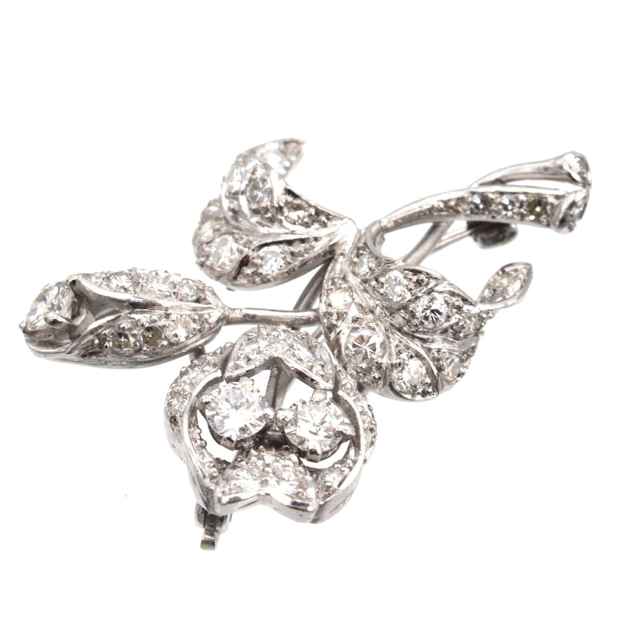 1950s 18ct white gold brooch with diamond flower spray design, symbolizing love and elegance.