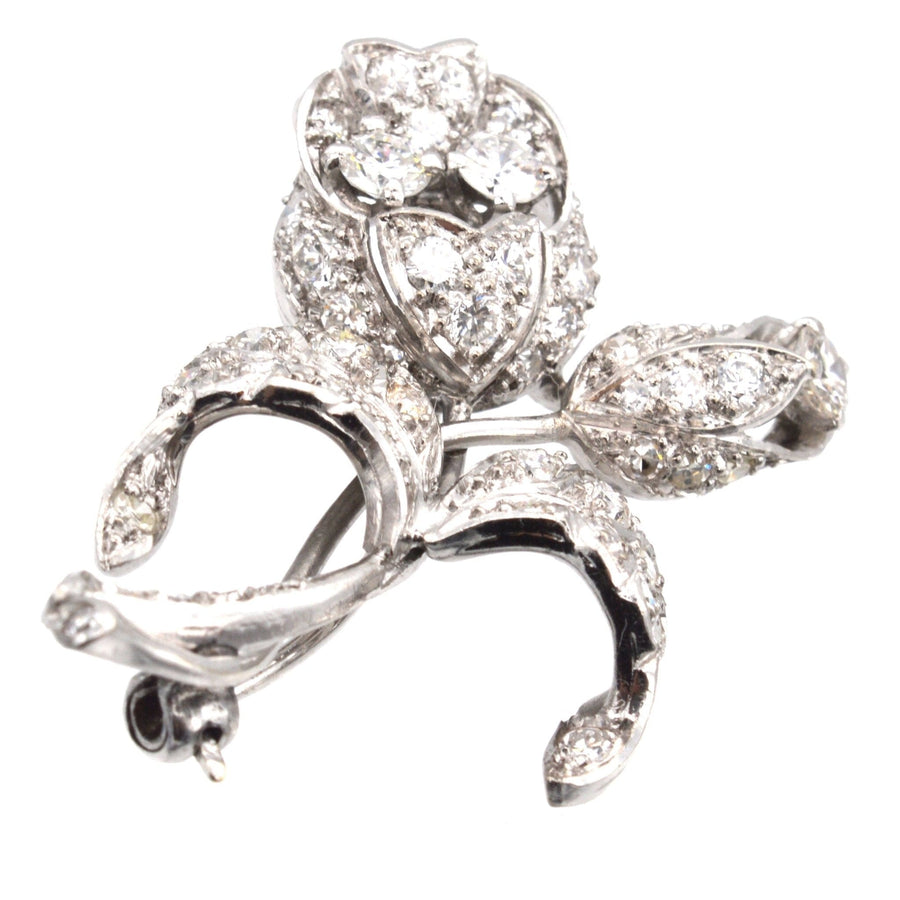 1950s 18ct white gold diamond flower spray brooch with sculptural design and floral motifs, symbolizing love.