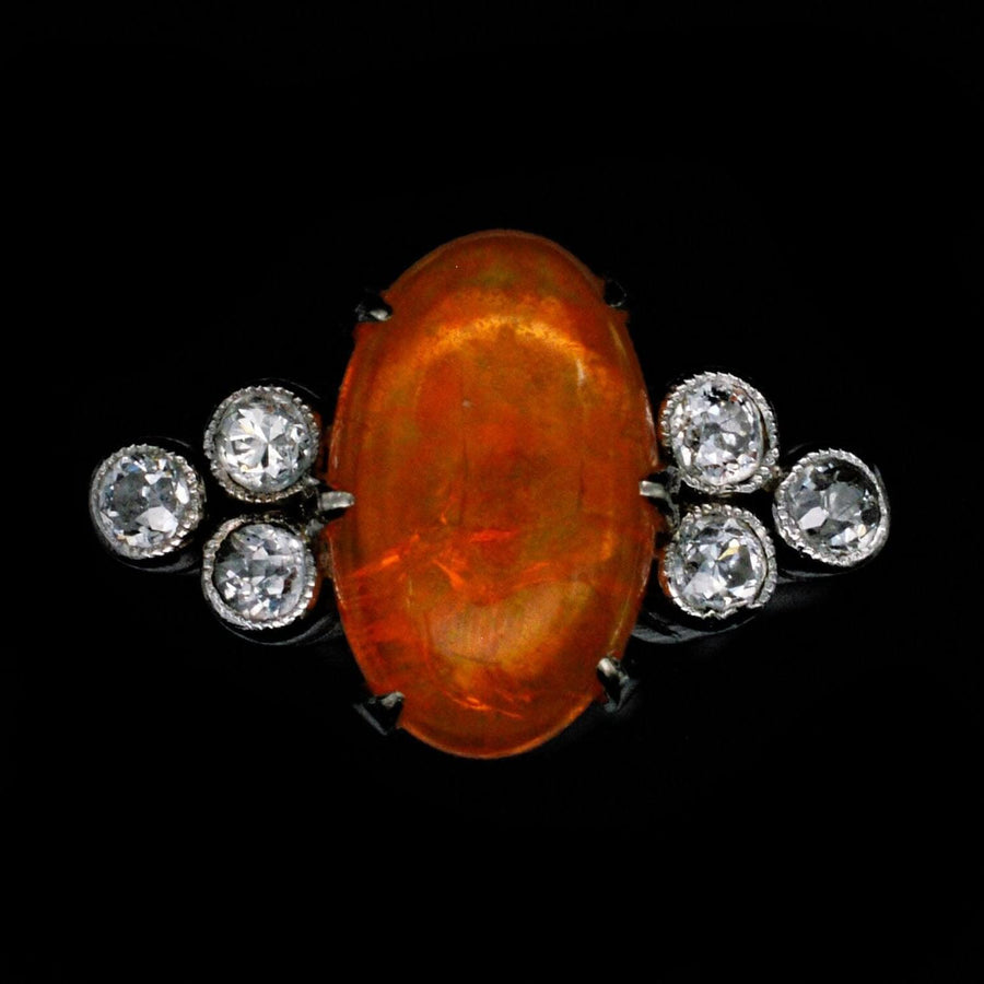 1960s Boodles platinum ring featuring a rare fire opal and sparkling diamonds, showcasing exquisite vintage elegance.