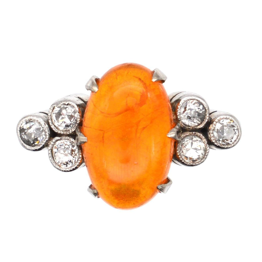 1960s Boodles platinum ring featuring a dazzling fire jelly opal surrounded by sparkling diamonds.
