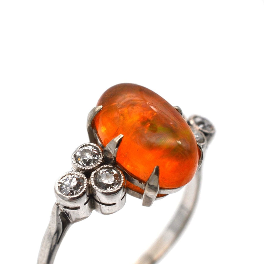 1960s Boodles platinum ring featuring a stunning fire opal and diamond accents.