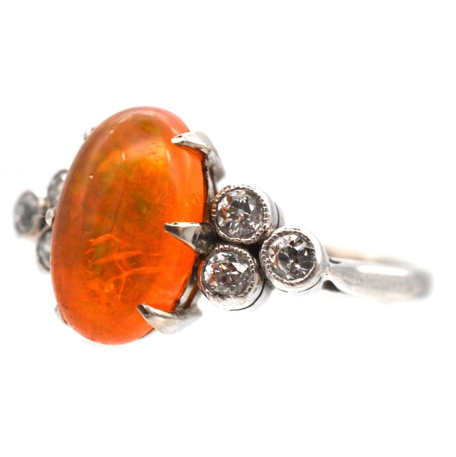1960s Boodles platinum ring featuring a rare fire opal and diamond accents, showcasing vibrant orange hues.