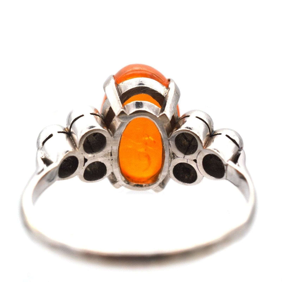 1960s Boodles platinum ring featuring a vibrant fire opal and diamond accents, showcasing vintage elegance.