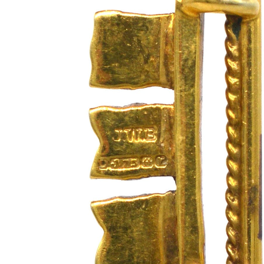 Close-up of 1970s vintage 9ct gold nautical signal flag brooch, featuring letters spelling Elizabeth.