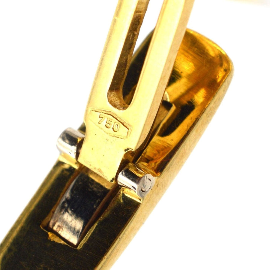 Close-up of a 750 gold hallmark on a cufflink, showcasing high-quality craftsmanship and design.