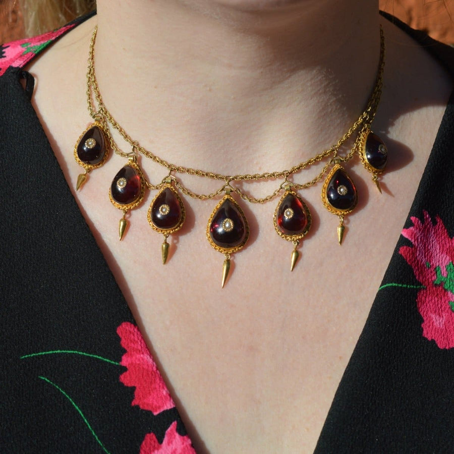 19th century 15ct gold necklace featuring cabochon garnets and seed pearls, showcasing elegant craftsmanship.