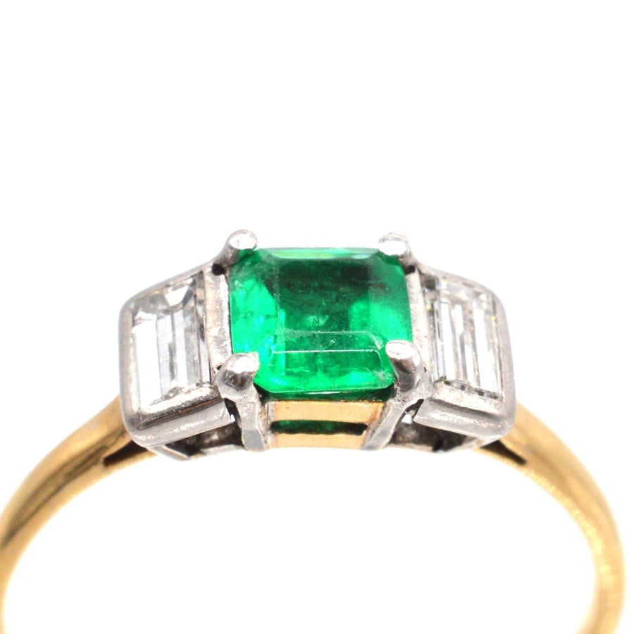 Art Deco 18ct gold and platinum three stone ring featuring a Colombian emerald and baguette cut diamonds.
