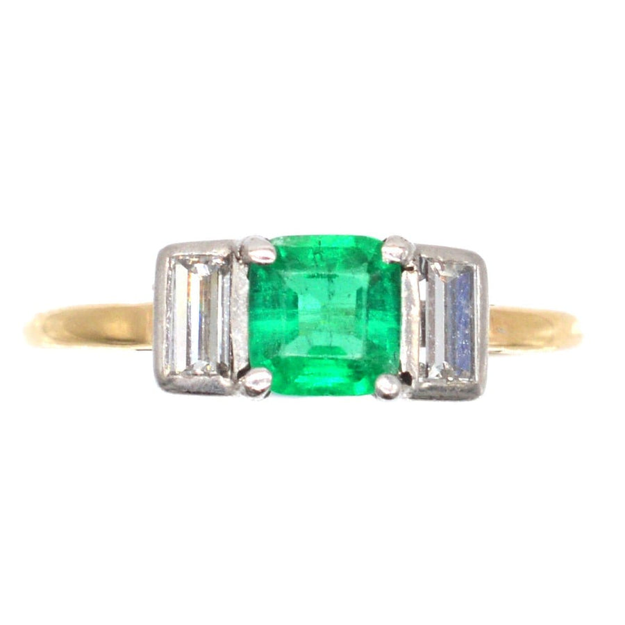 Art Deco 18ct gold & platinum ring featuring a vibrant Columbian emerald flanked by two baguette cut diamonds.