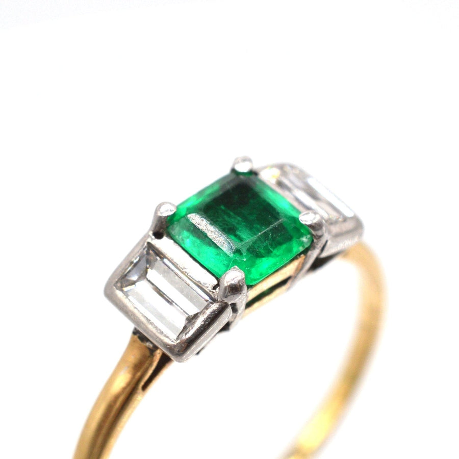 Art Deco 18ct gold and platinum ring featuring a Columbian emerald and diamond baguette stones.