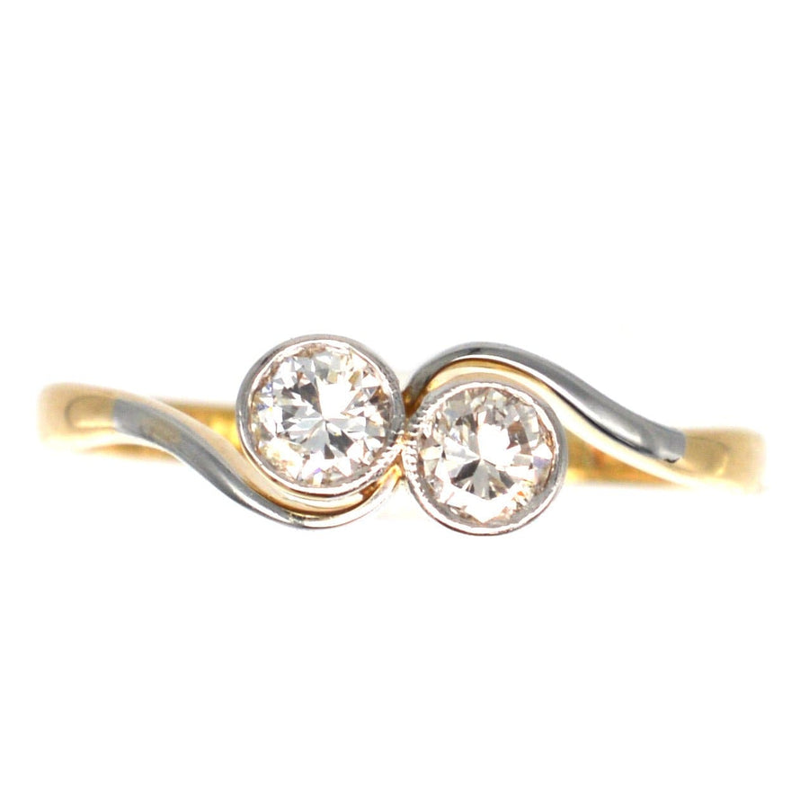 Art Deco 18ct gold and platinum 'Toi et Moi' crossover ring with two stone diamonds, symbolizing love.