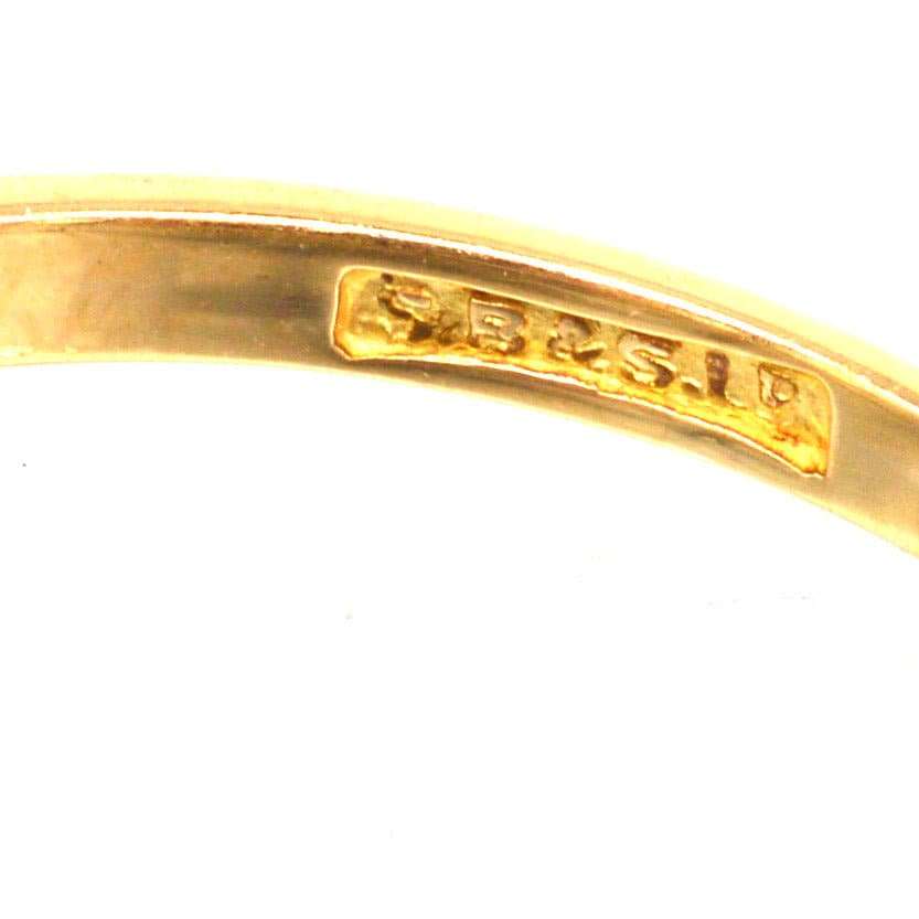 Close-up of the hallmark on the inner band of an Art Deco gold and platinum diamond ring.