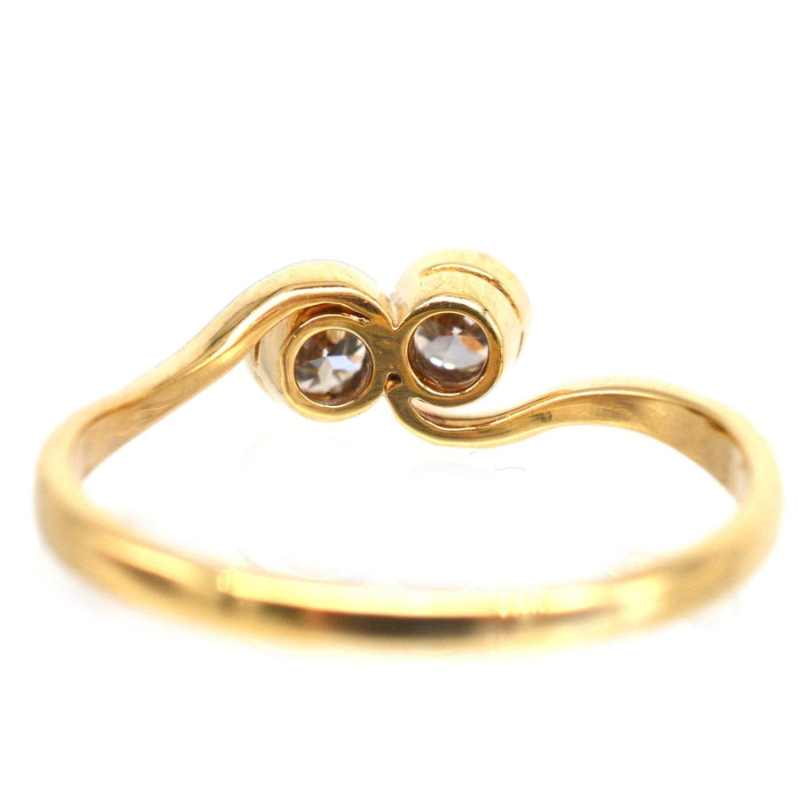 Art Deco 18ct gold & platinum Toi et Moi two stone diamond crossover ring, symbolizing love and connection.