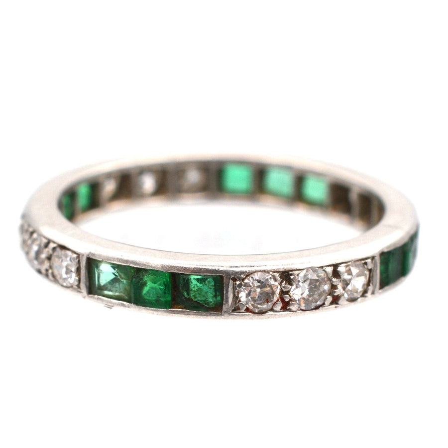 Art Deco 18ct white gold eternity ring with emerald and diamond inlay, size UK L, symbol of everlasting love.