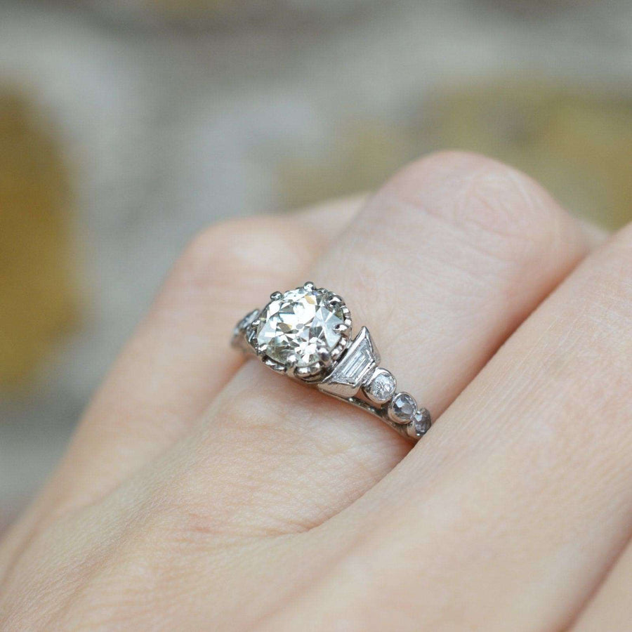 Art Deco platinum large diamond solitaire ring with diamond shoulders, showcasing elegant vintage design and craftsmanship.