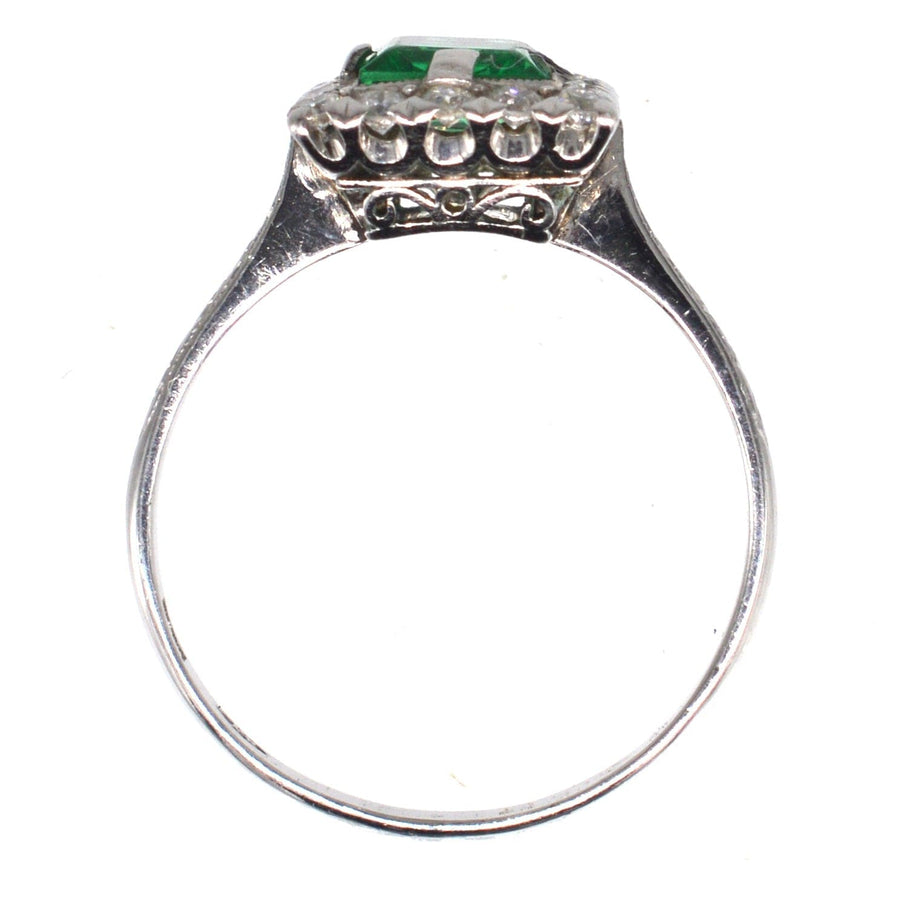 Art Deco platinum rectangular emerald and diamond cluster ring with exquisite engraving, perfect for an engagement.