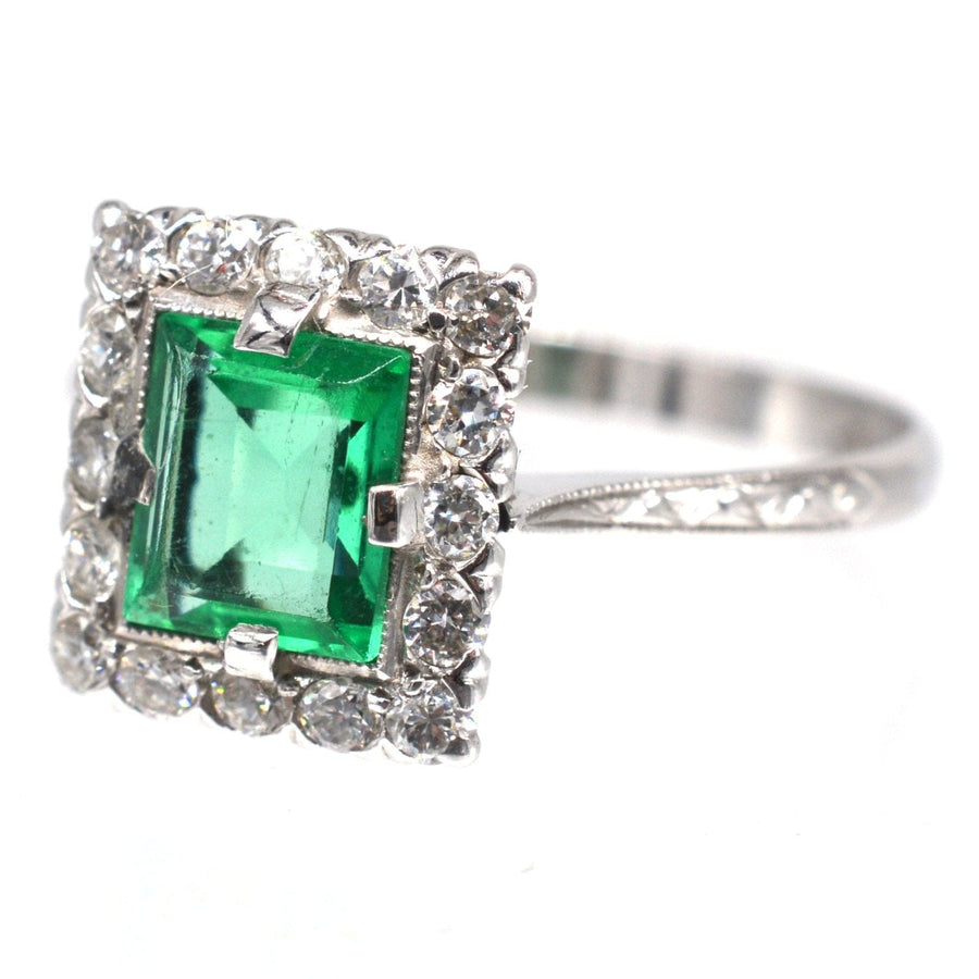 Art Deco platinum rectangular emerald and diamond cluster ring, stunning engagement piece with intricate engraving.