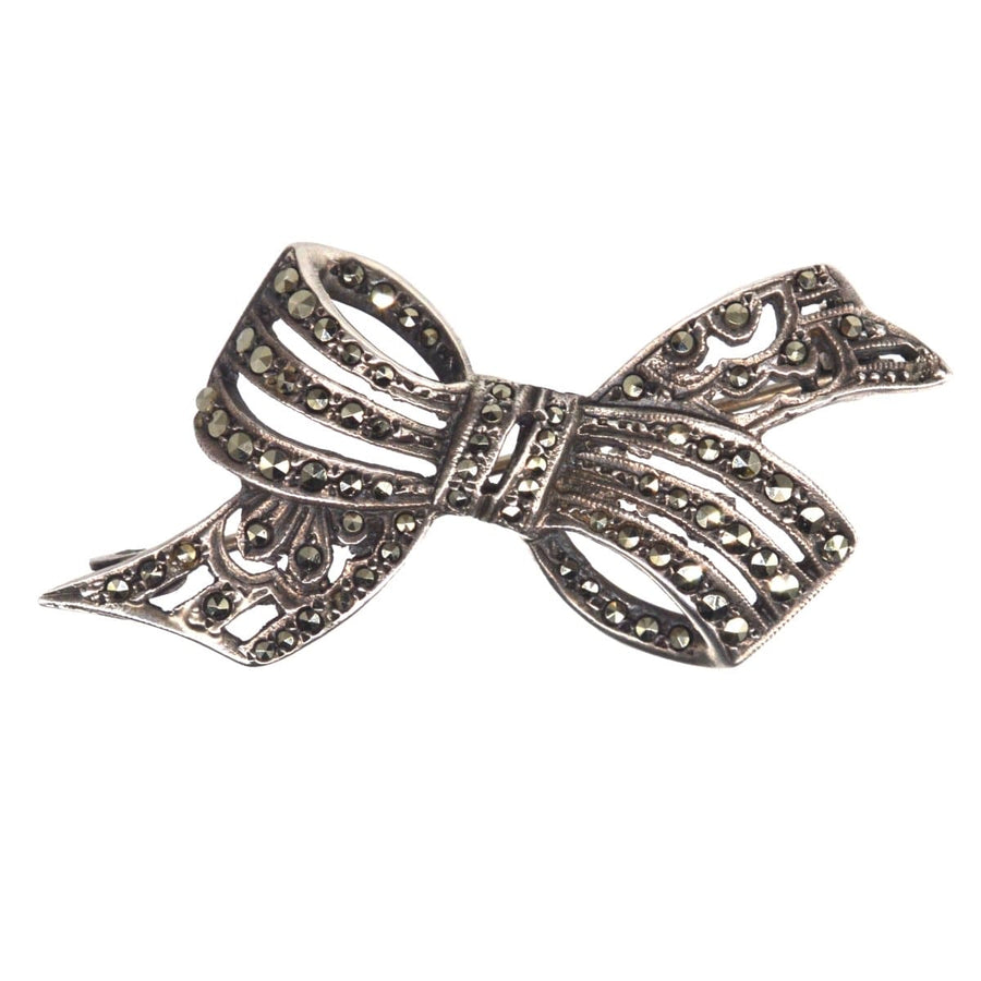 Art Deco silver and marcasite bow brooch, featuring a sculptural design and intricate detailing, ideal for vintage jewelry lovers.