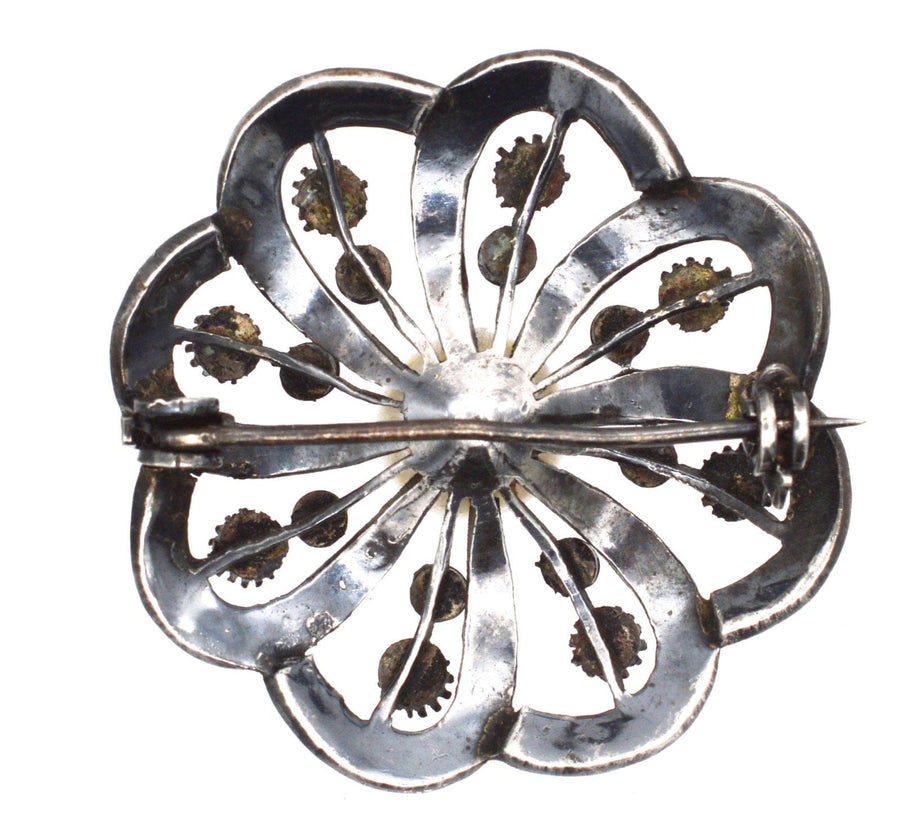 Art Deco silver brooch featuring marcasite embellishments and flower design, vintage German jewelry from the 1930s.
