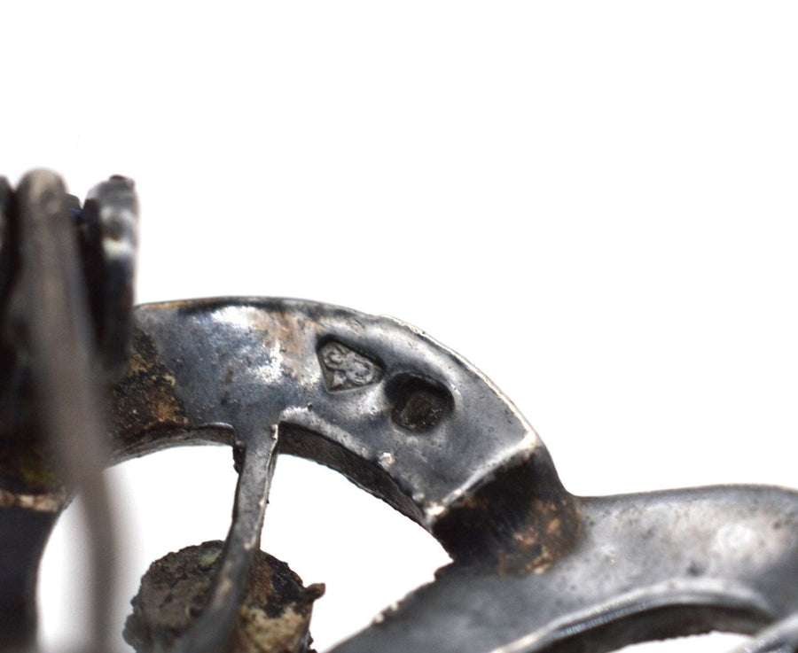 Close-up of the hallmark on an Art Deco silver marcasite brooch, showcasing intricate vintage craftsmanship.