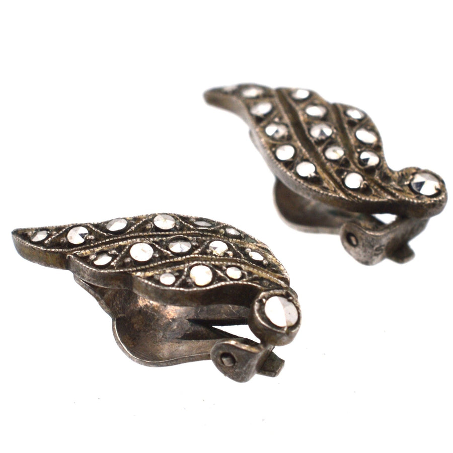 Art Deco silver marcasite winged clip-on earrings with geometric design from the 1920s, reflecting vintage elegance.