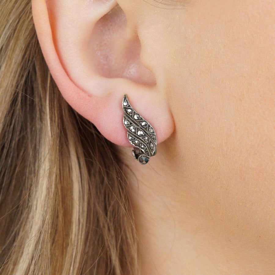 Art Deco silver marcasite winged clip on earrings, showcasing a vintage design popular in the 1920s.