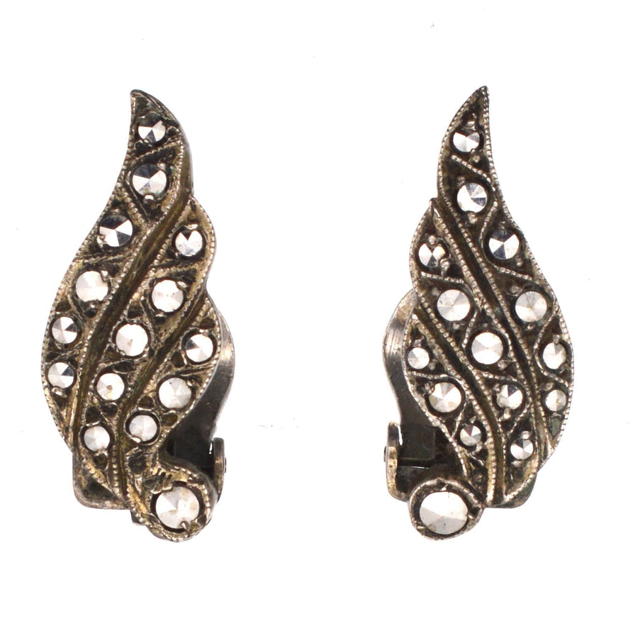 Art Deco silver marcasite winged clip-on earrings from the 1920s featuring geometric designs and sparkling stones.