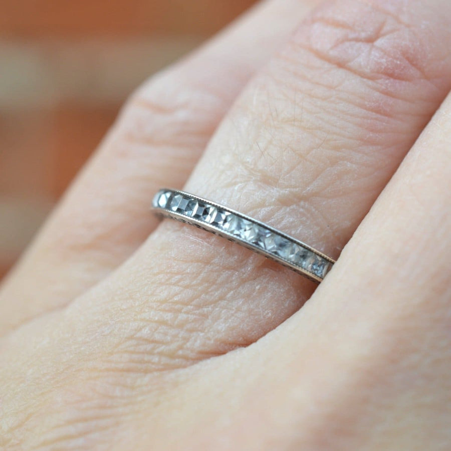 Art Deco silver paste eternity ring showcased on a hand, resembling a diamond band, symbolizing everlasting love.
