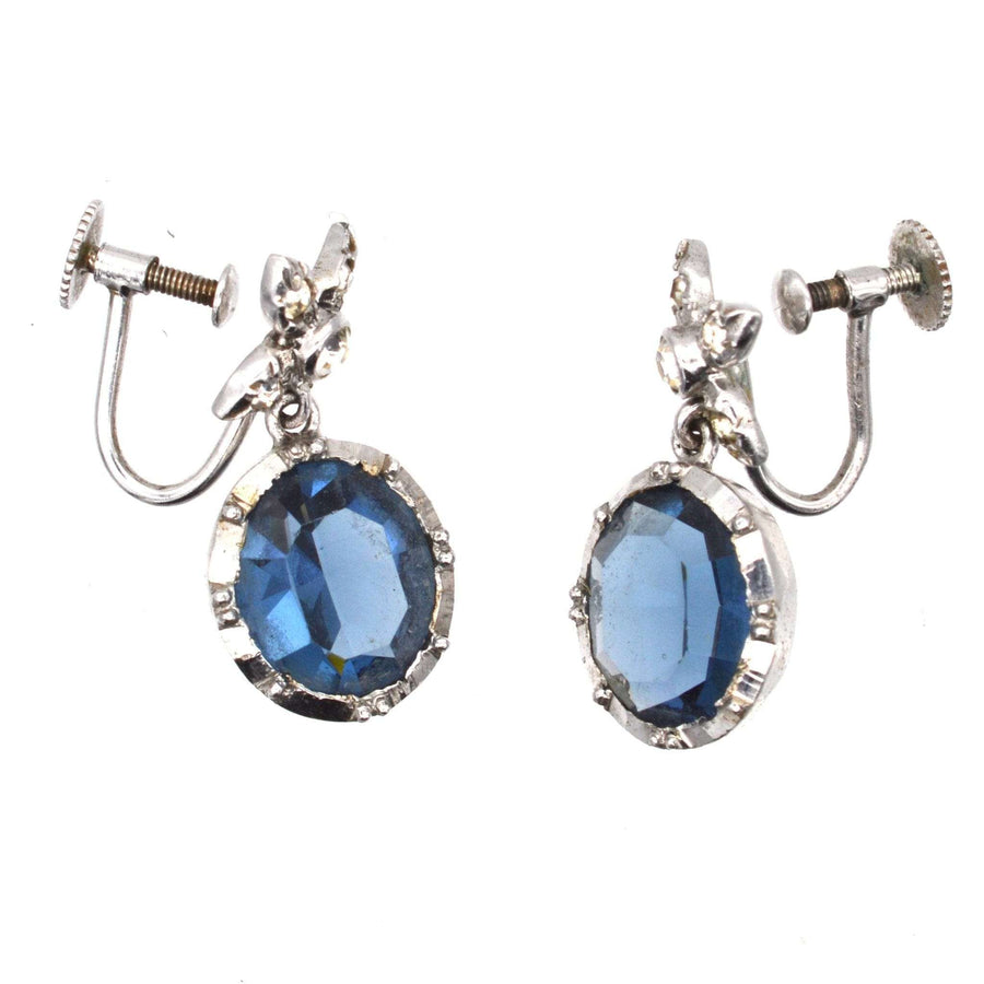 Art Deco silver earrings with blue paste stones and intricate diamond paste embellishments.