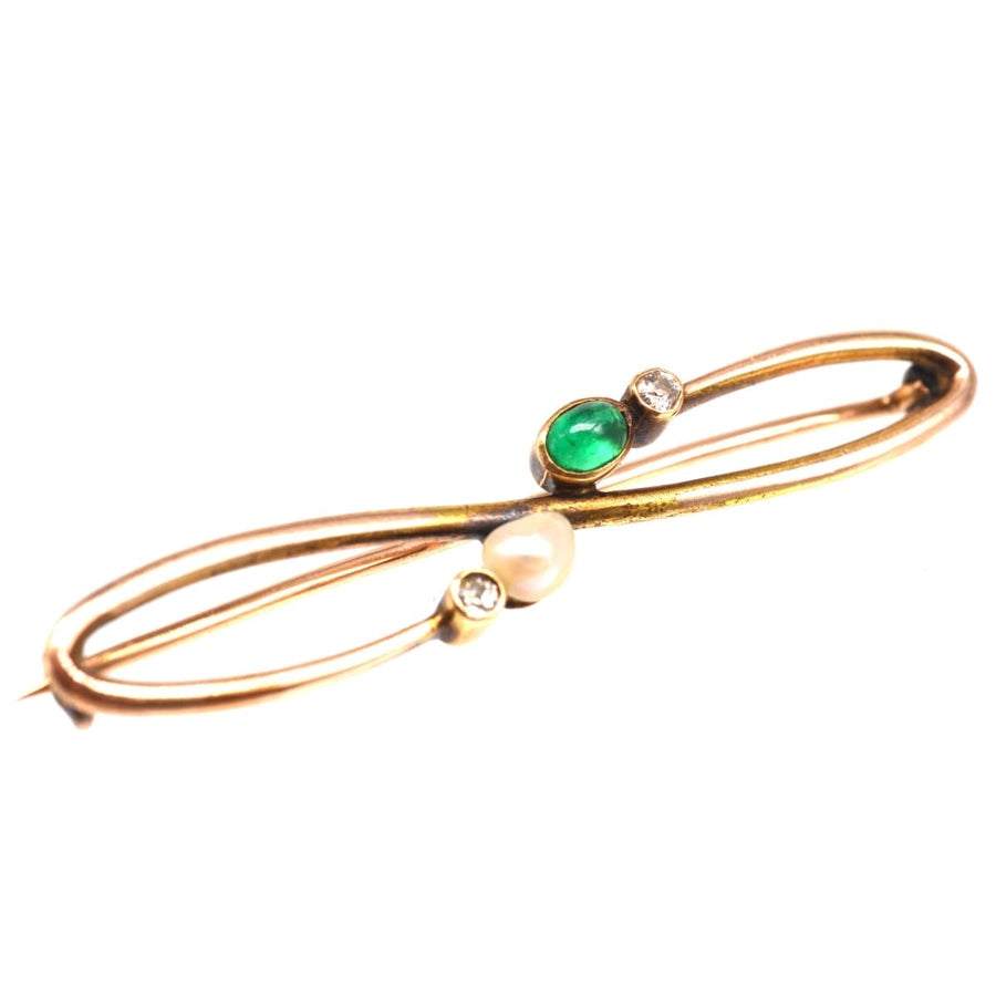 Art Nouveau 15ct gold brooch featuring an emerald, natural pearl, and diamond accents, elegant lapel accessory.