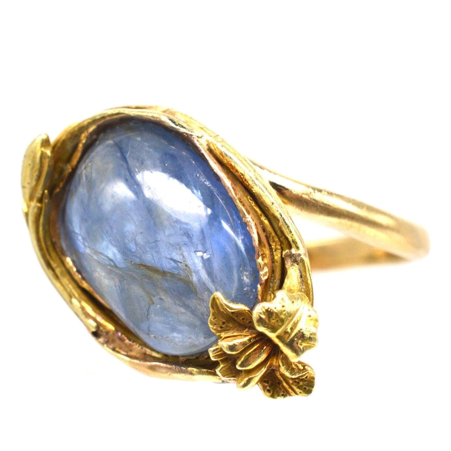 Art Nouveau 18ct gold ring featuring a 6-carat blue Kyanite cabochon with floral detailing.