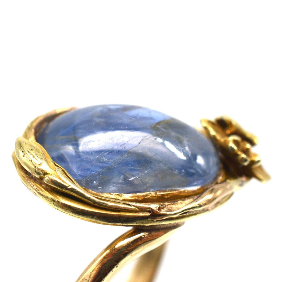 Art Nouveau 18ct gold ring featuring a large cabochon Kyanite and flower design.