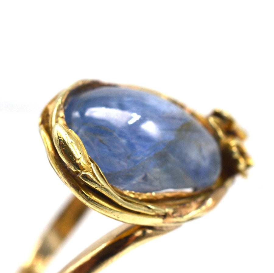 Art Nouveau 18ct gold ring featuring a large cabochon kyanite stone with floral detailing.
