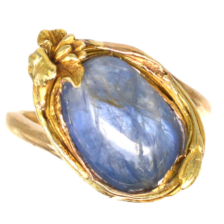Art Nouveau 18ct gold ring featuring a large cabochon kyanite gem with floral design.