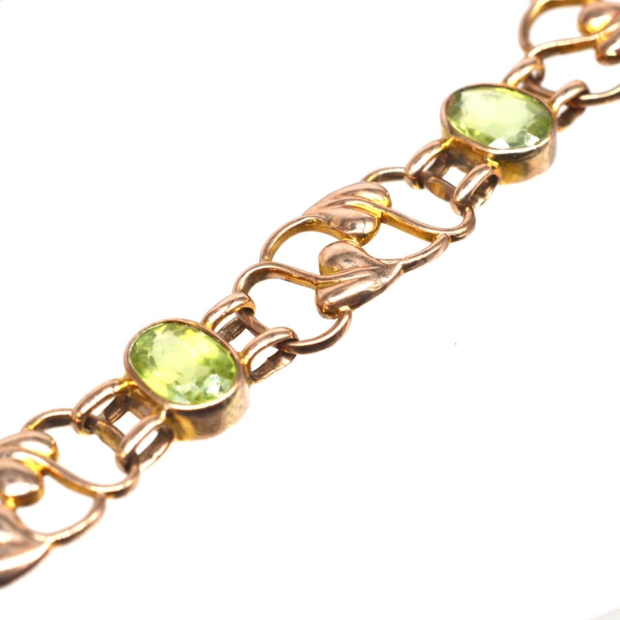 Art Nouveau 9ct gold bracelet featuring six peridots and a stylized leaf pattern, dating back to the 1910s.