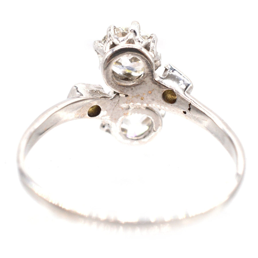 Belle Époque platinum and diamond 'Toi et Moi' crossover ring, showcasing two diamonds in a romantic design.