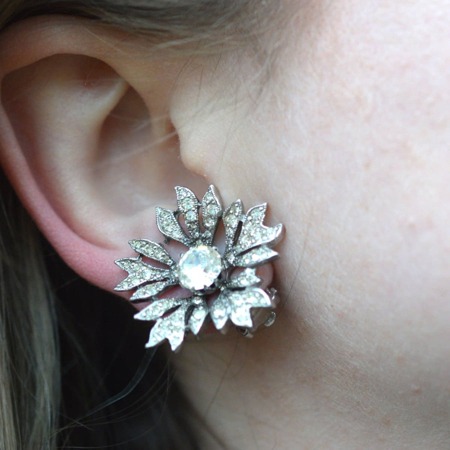 Vintage Christian Dior 1950s paste flower earrings in rhodium, featuring a sparkling central stone.