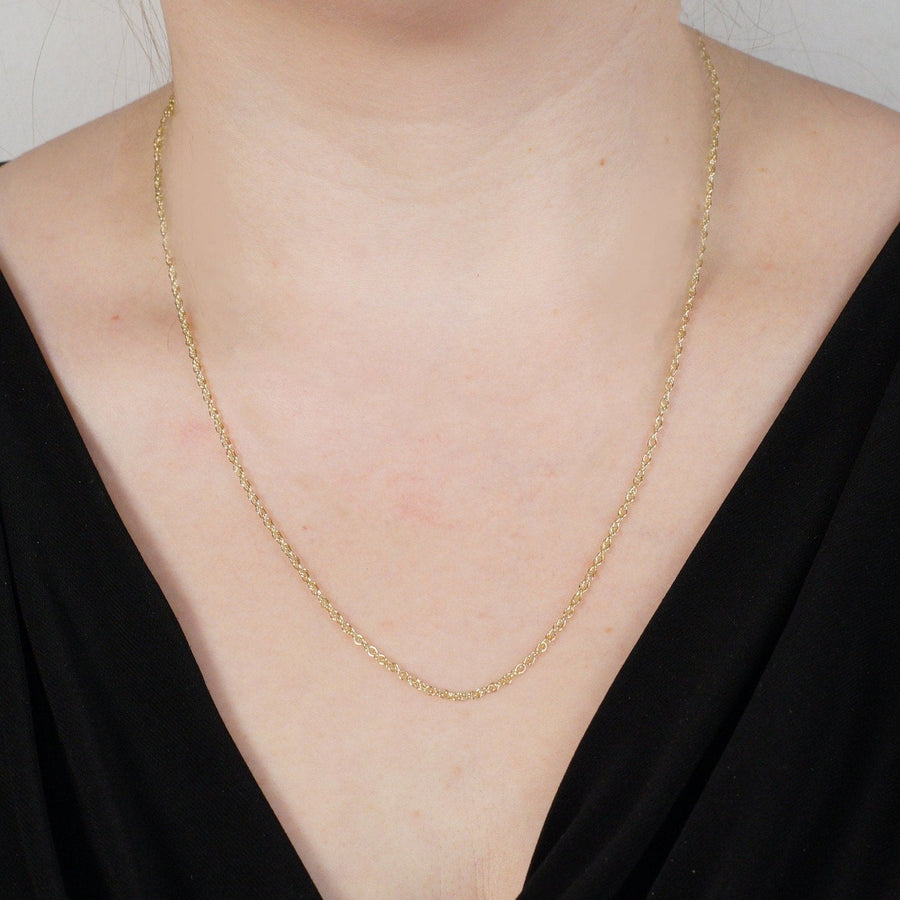 Close-up of a 9ct yellow gold Prince of Wales rope chain worn by a model, showcasing its elegant design and shine.