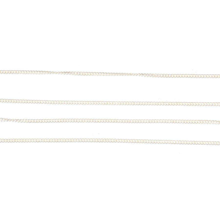 Contemporary silver curb chains laid flat, showcasing polished finish and classic pattern. Available in 18"/45cm length.
