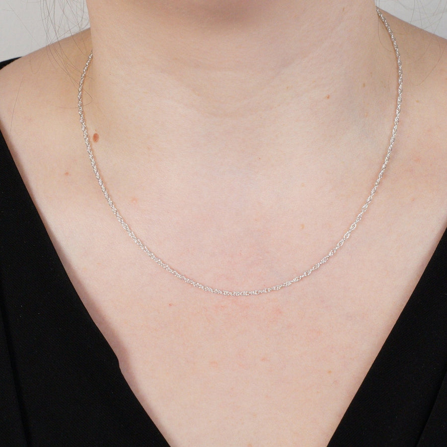Close-up of a woman wearing a polished silver Prince of Wales rope chain, 18 inches long, showcasing elegant craftsmanship.